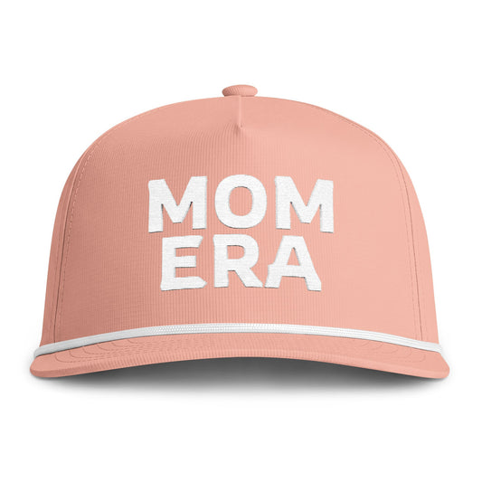 Image of a peach hat with white embroidery reading "Mom Era"
